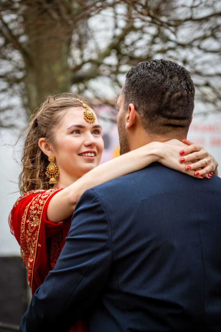 Couple gazing into each other's eyes at the entrance of Brundlund Castle, sharing an intimate and loving moment.