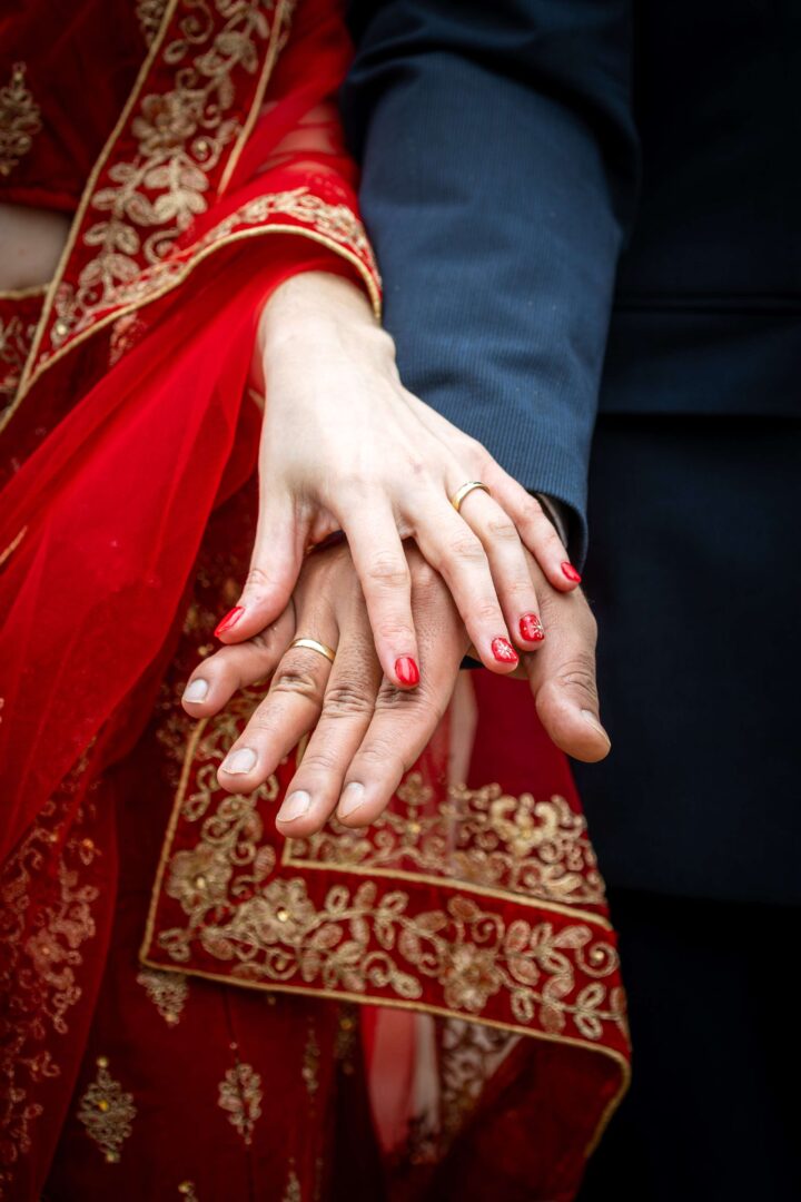 Close-up of hands gently touching, capturing a romantic detail shot symbolizing love and connection.