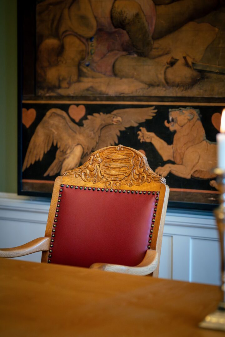 Chair in Aabenraa Town Hall with the town's coat of arms intricately carved into the backrest.