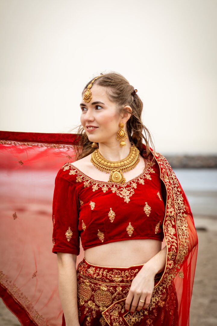 Portrait of a woman in a red traditional dress, radiating elegance and grace.