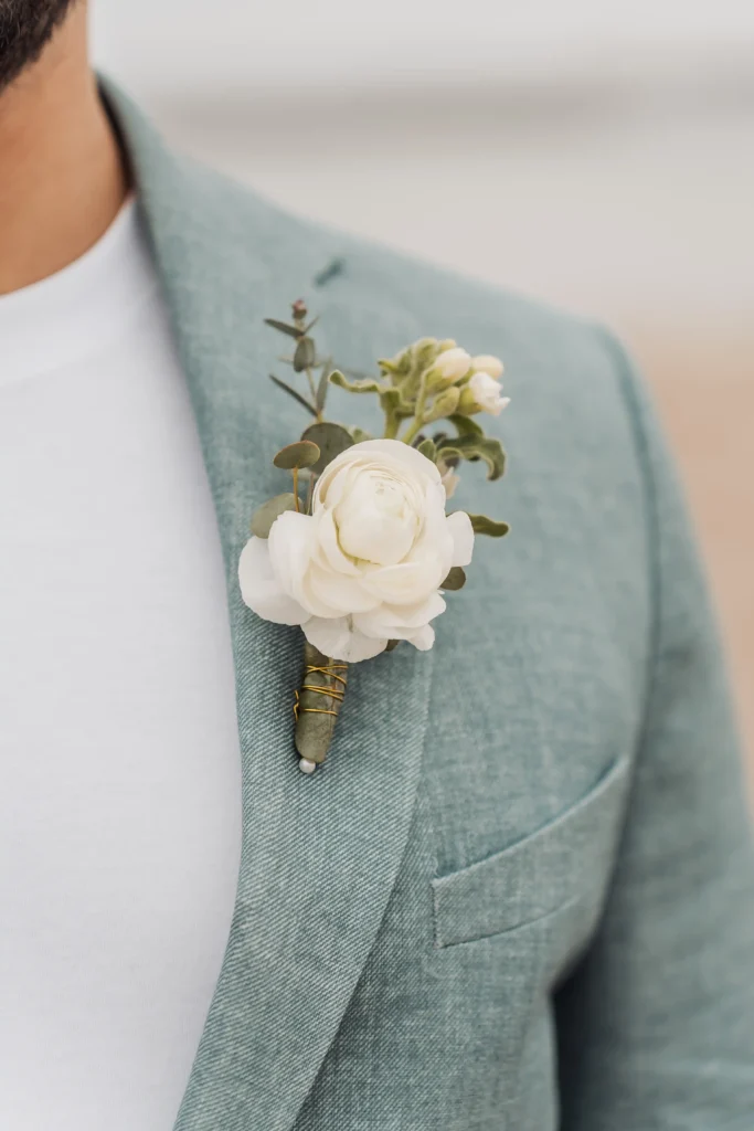 Close-up of the boutonniere pinned to his lapel