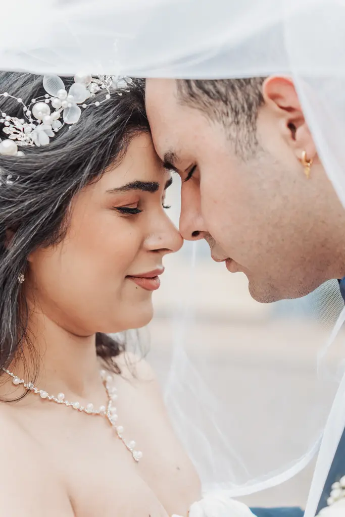 couple touching foreheads under the veil on Old Street in Aabenraa