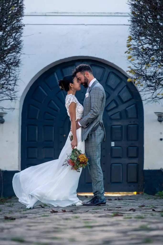 couple standing close at the entrance of Brundlund Castle in Aabenraa